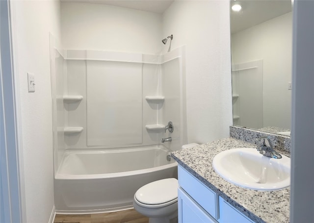 full bathroom with bathing tub / shower combination, toilet, vanity, and hardwood / wood-style flooring