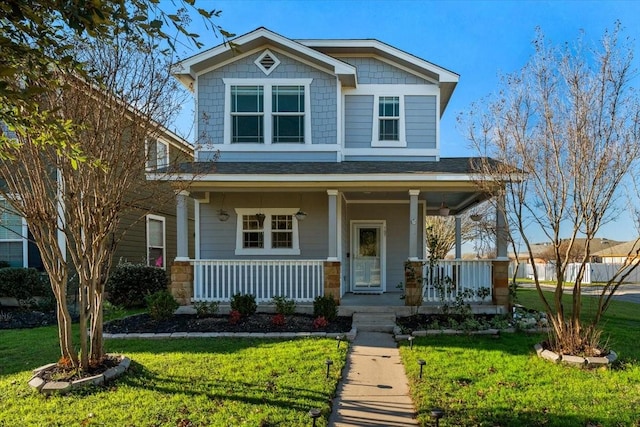 craftsman-style house featuring a front lawn and covered porch