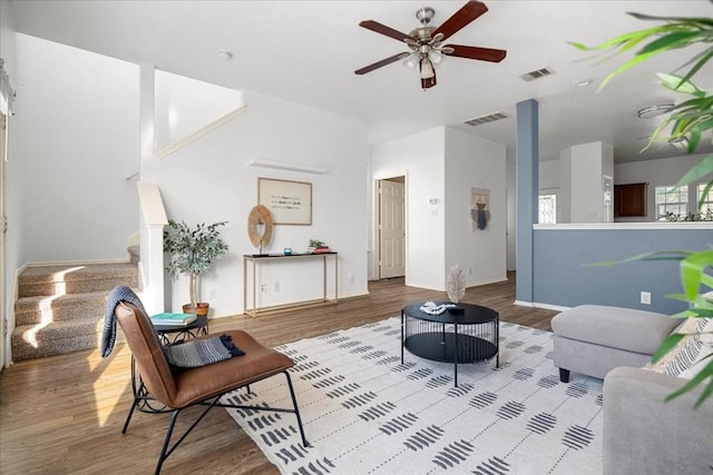 living room featuring ceiling fan and hardwood / wood-style flooring