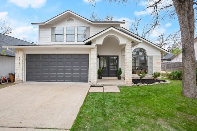 view of front of home featuring a garage, a front yard, and french doors