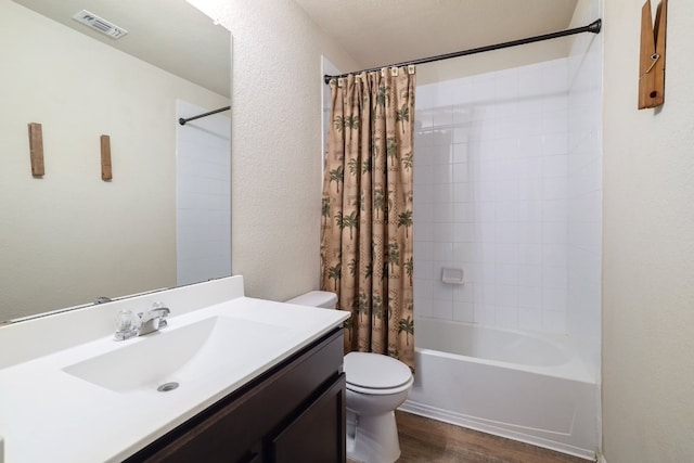 12110 Riprap Dr, Manor, TX 78653 - full bathroom featuring toilet, vanity, wood finished floors, shower / tub combo, and a textured wall