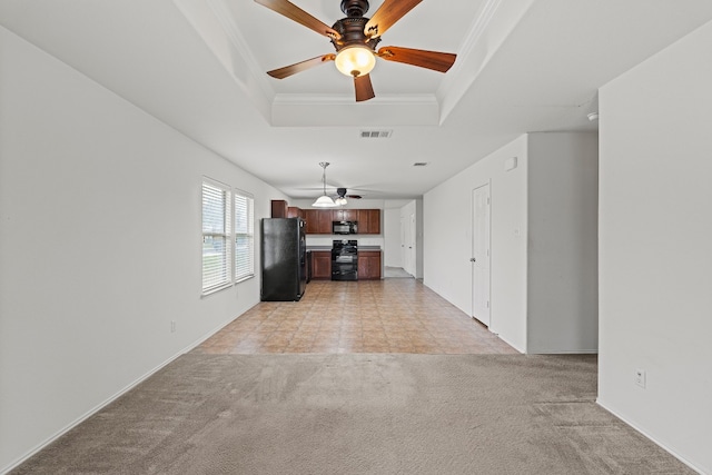 unfurnished living room with a tray ceiling, light carpet, crown molding, and ceiling fan