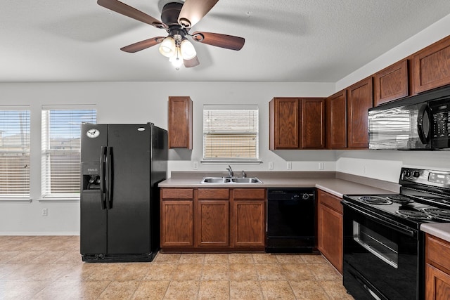 kitchen with a wealth of natural light, sink, ceiling fan, and black appliances