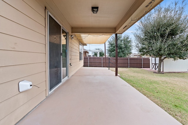 view of patio / terrace featuring a storage unit