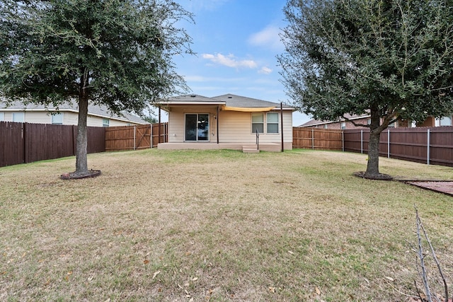 back of house featuring a yard