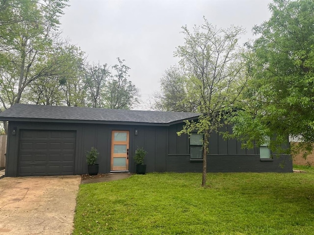 single story home featuring a front lawn and a garage