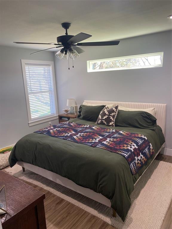 bedroom with hardwood / wood-style floors and ceiling fan