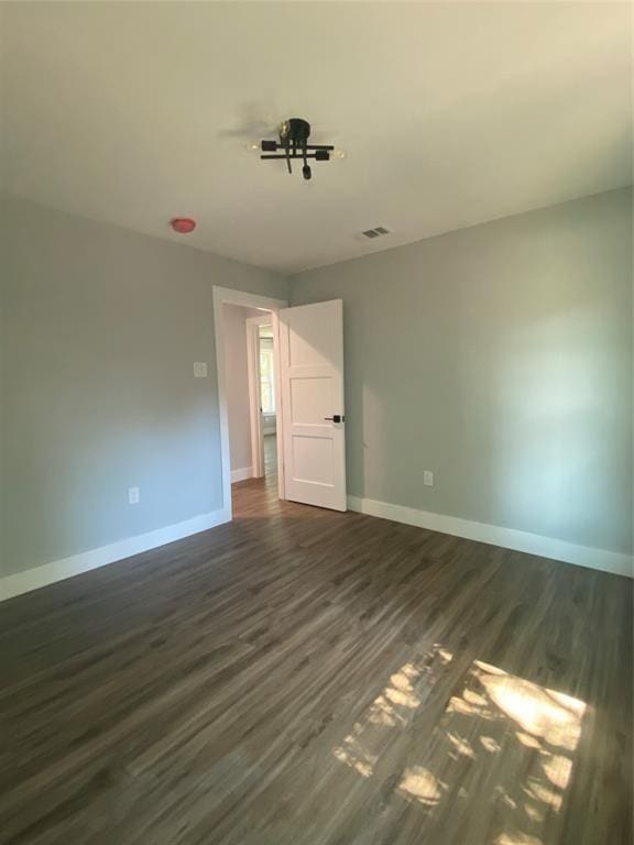 spare room featuring dark wood-type flooring