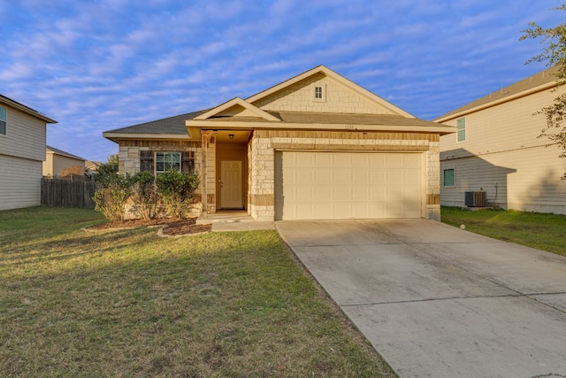 view of front facade with central AC, a front yard, and a garage