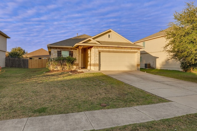 ranch-style house featuring a front lawn, a garage, and central AC