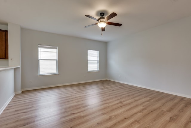 empty room featuring ceiling fan and light hardwood / wood-style flooring