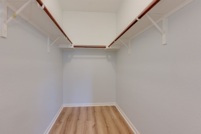 spacious closet featuring light hardwood / wood-style floors