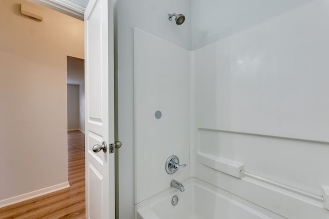 bathroom with shower / bathing tub combination and hardwood / wood-style floors