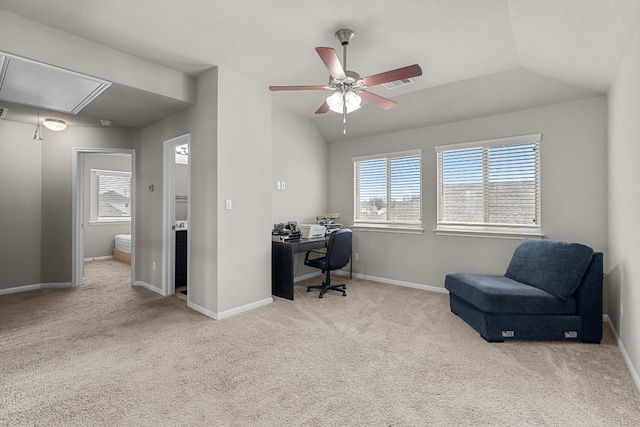 carpeted office space with ceiling fan, plenty of natural light, and vaulted ceiling