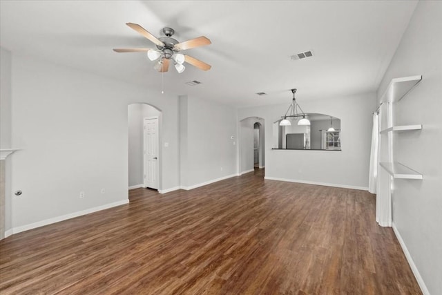 unfurnished living room featuring dark hardwood / wood-style flooring and ceiling fan