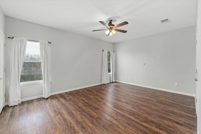 unfurnished room featuring ceiling fan and dark wood-type flooring