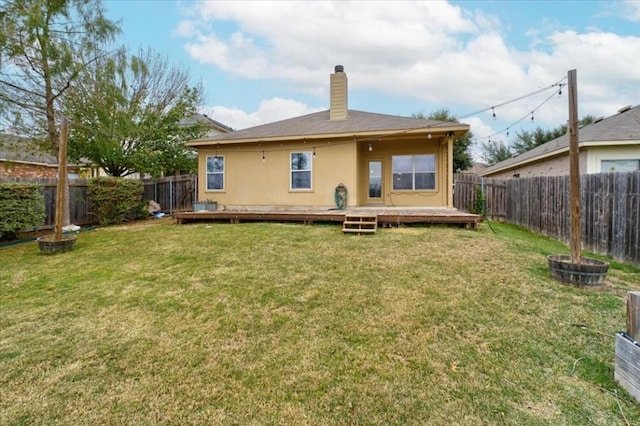 back of property featuring a yard and a deck