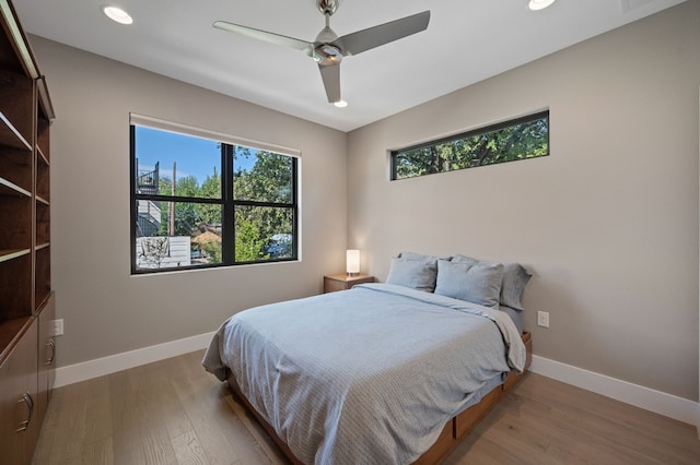 bedroom with hardwood / wood-style flooring and ceiling fan