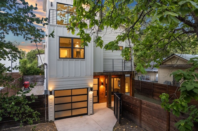 modern home featuring a garage and a balcony