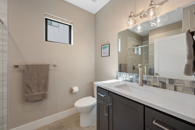 bathroom with vanity, toilet, and a shower with shower door