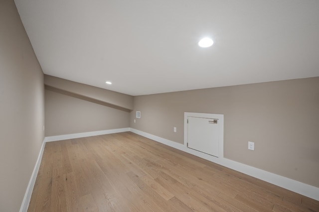 additional living space with light hardwood / wood-style flooring