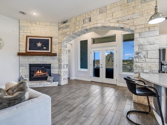 living room with french doors and a fireplace