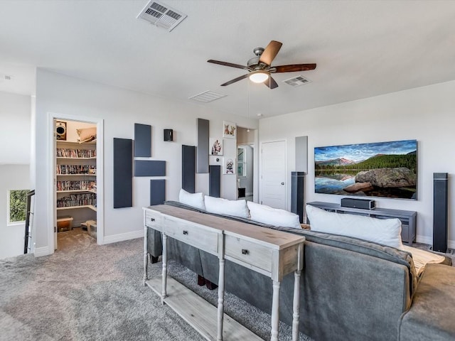 carpeted living room with ceiling fan