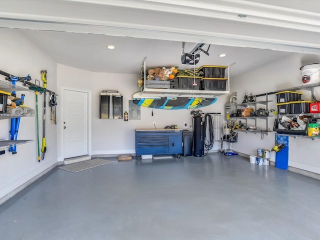 garage with electric panel and a garage door opener