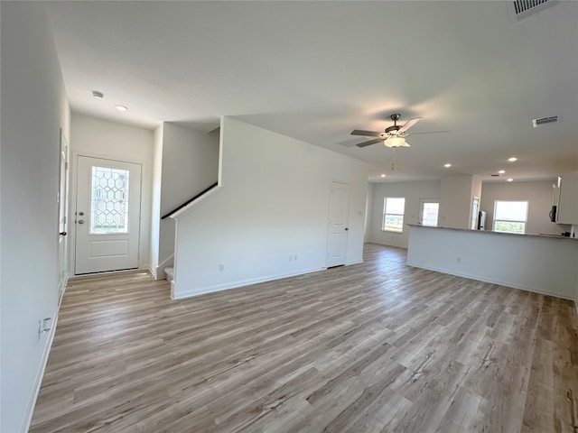 unfurnished living room featuring light hardwood / wood-style flooring and ceiling fan