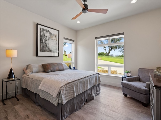 bedroom featuring hardwood / wood-style floors and ceiling fan