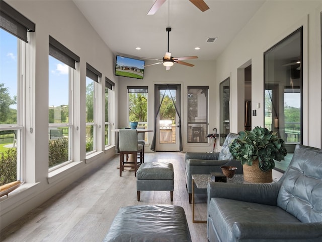 sunroom featuring ceiling fan