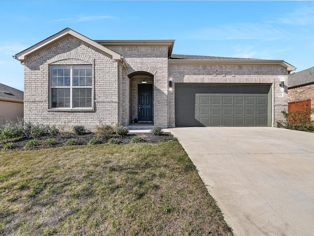 view of front of property featuring a garage and a front lawn