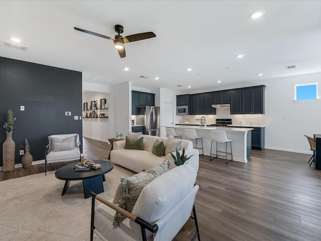 living room with ceiling fan and dark hardwood / wood-style floors