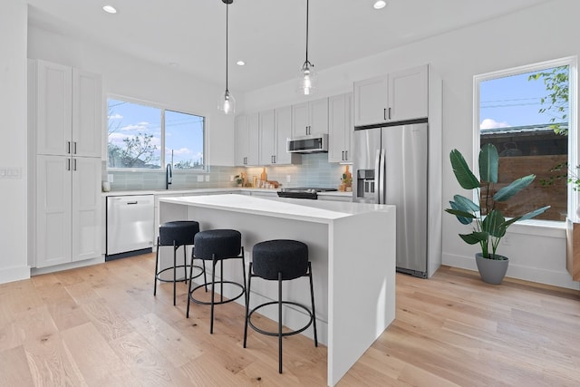 kitchen featuring a center island, white cabinetry, and stainless steel appliances