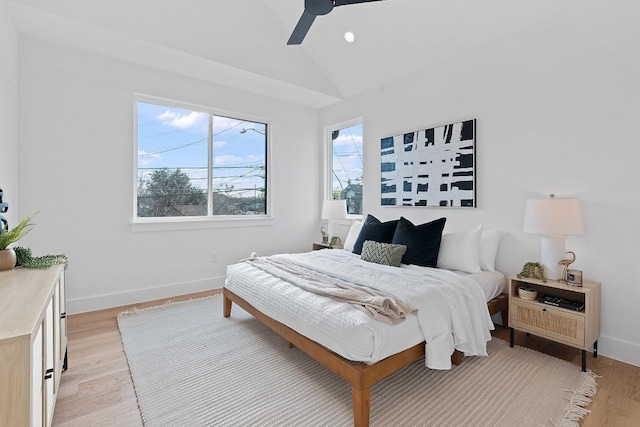 bedroom featuring ceiling fan, light hardwood / wood-style floors, and vaulted ceiling