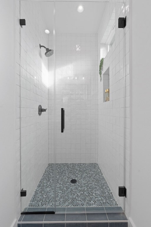 bathroom featuring tile patterned flooring and walk in shower