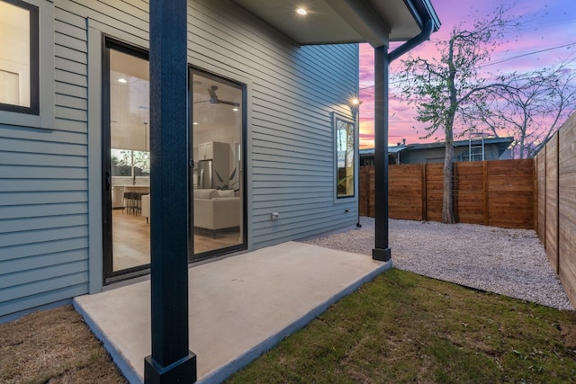 view of patio terrace at dusk