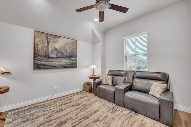 living room with hardwood / wood-style flooring and ceiling fan