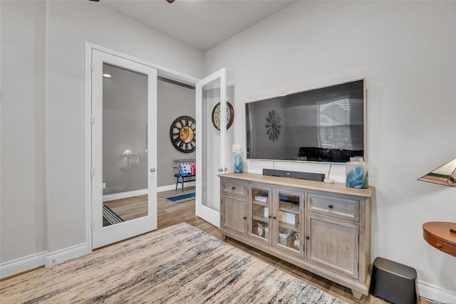 living room featuring french doors and light hardwood / wood-style floors