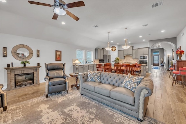 living room featuring ceiling fan and light hardwood / wood-style floors