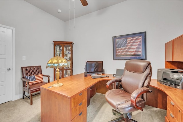 carpeted home office featuring vaulted ceiling and ceiling fan