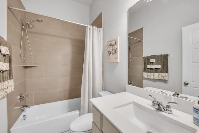 full bathroom with shower / tub combo with curtain, vanity, and toilet