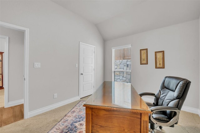 home office featuring carpet flooring and vaulted ceiling