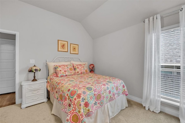 carpeted bedroom with vaulted ceiling