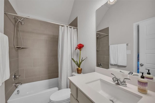 full bathroom featuring shower / bath combo with shower curtain, vanity, vaulted ceiling, and toilet