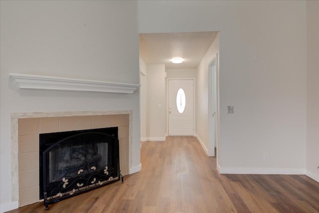 entrance foyer featuring hardwood / wood-style flooring and a tile fireplace