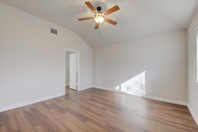 spare room featuring ceiling fan, wood-type flooring, and lofted ceiling