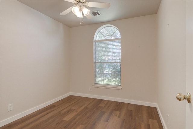 empty room with hardwood / wood-style floors and ceiling fan