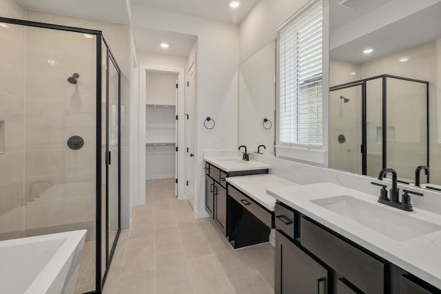 full bathroom with recessed lighting, a sink, tile patterned floors, and a shower stall