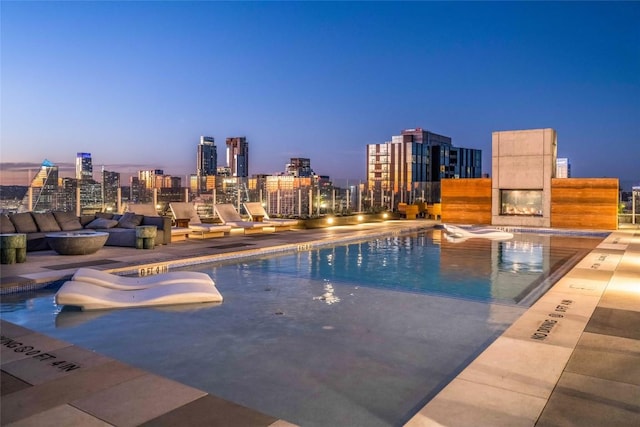 48 E Ave Unit 1607, Austin, TX 78701 - pool at dusk with a community pool, a skyline view, and a water slide